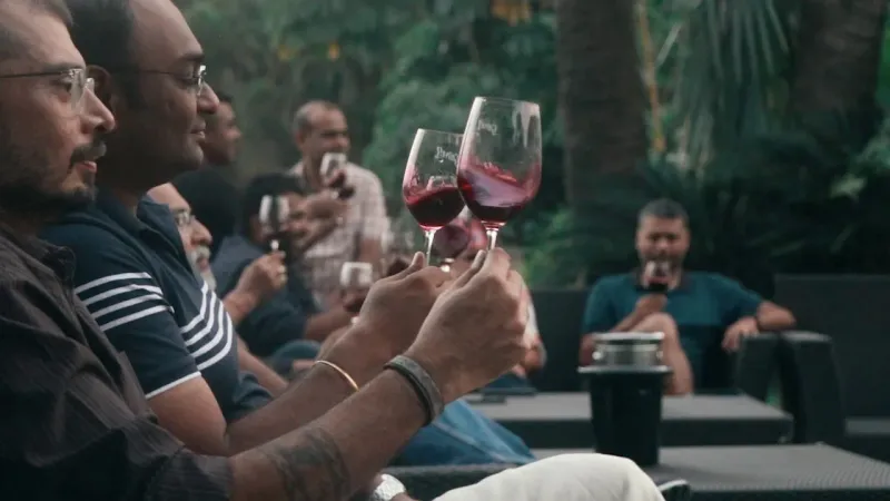 Tribe members raising glasses at a wine tasting