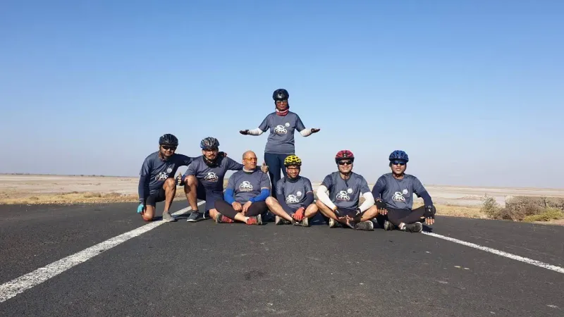 A group of riders sitting on an empty road